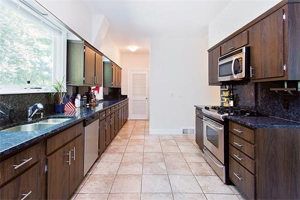 369 Dudley Road Newton, MA 02459 - Photo 4 of 9 a kitchen with stainless steel appliances granite countertop a stove a sink and a microwave