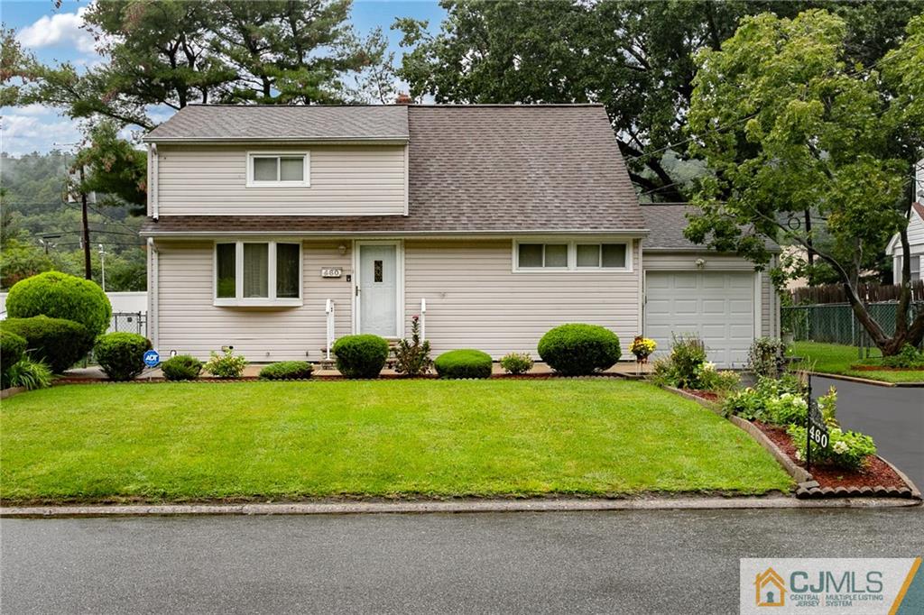 a front view of a house with a garden and plants