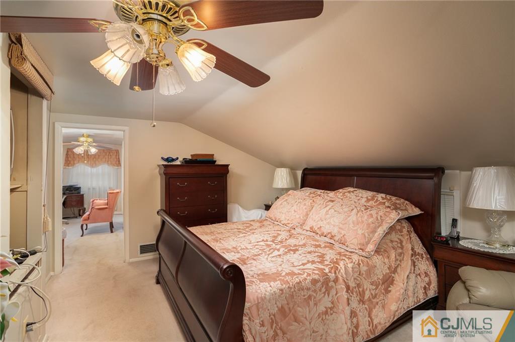 460 Warfield Road North Plainfield, NJ 07060 - Photo 13 of 29 a bedroom with a bed and a chandelier