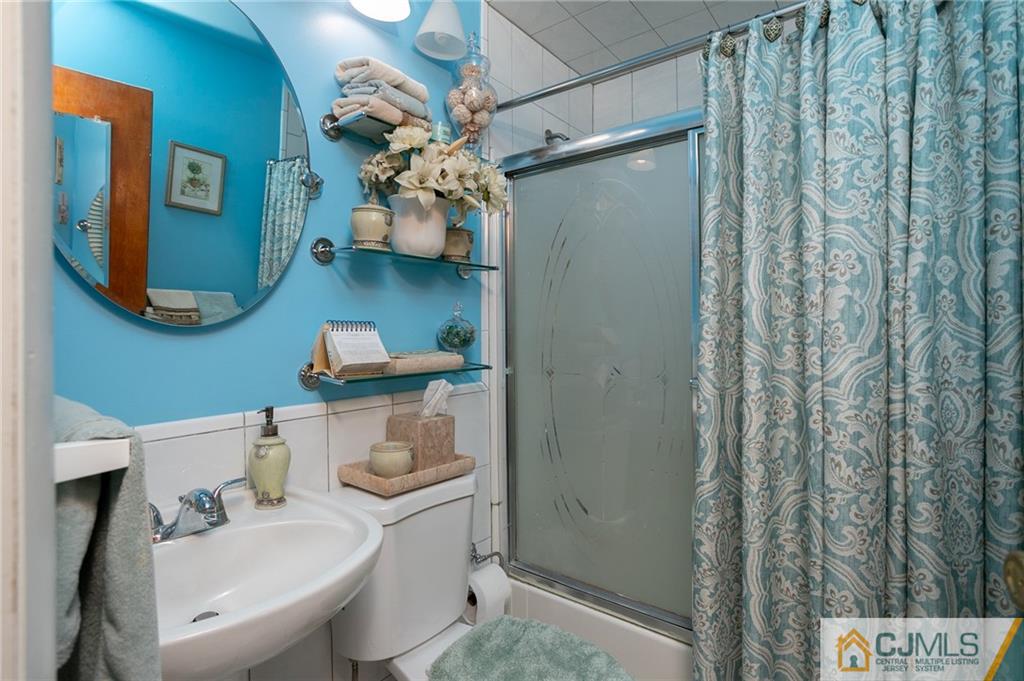 460 Warfield Road North Plainfield, NJ 07060 - Photo 18 of 29 a bathroom with a sink a mirror and a shower