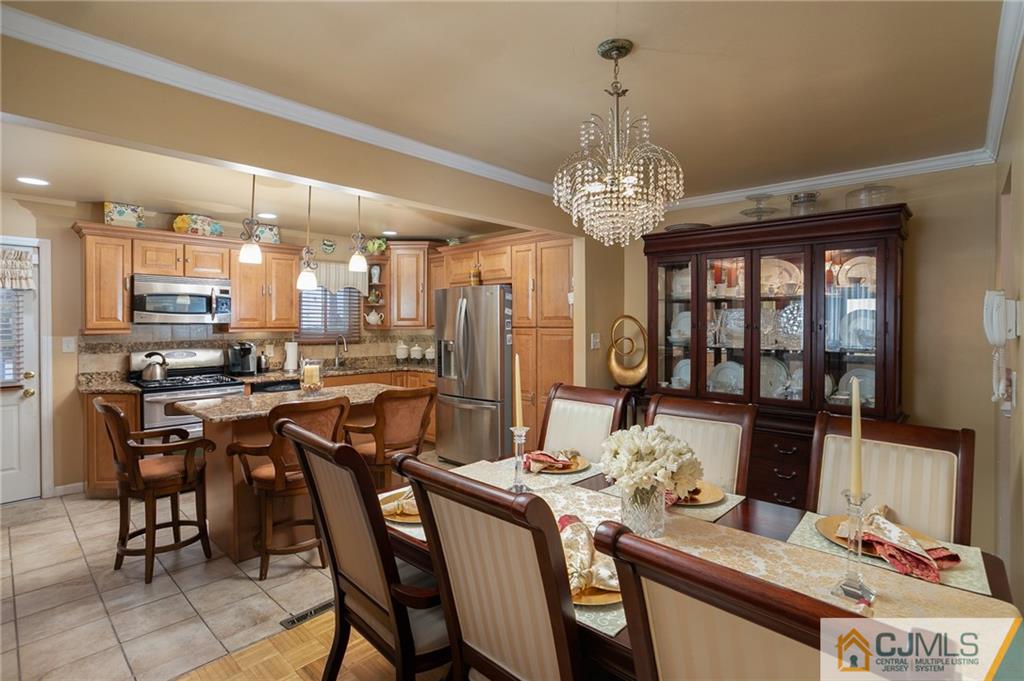 460 Warfield Road North Plainfield, NJ 07060 - Photo 8 of 29 a view of a dining room with furniture a chandelier and kitchen view