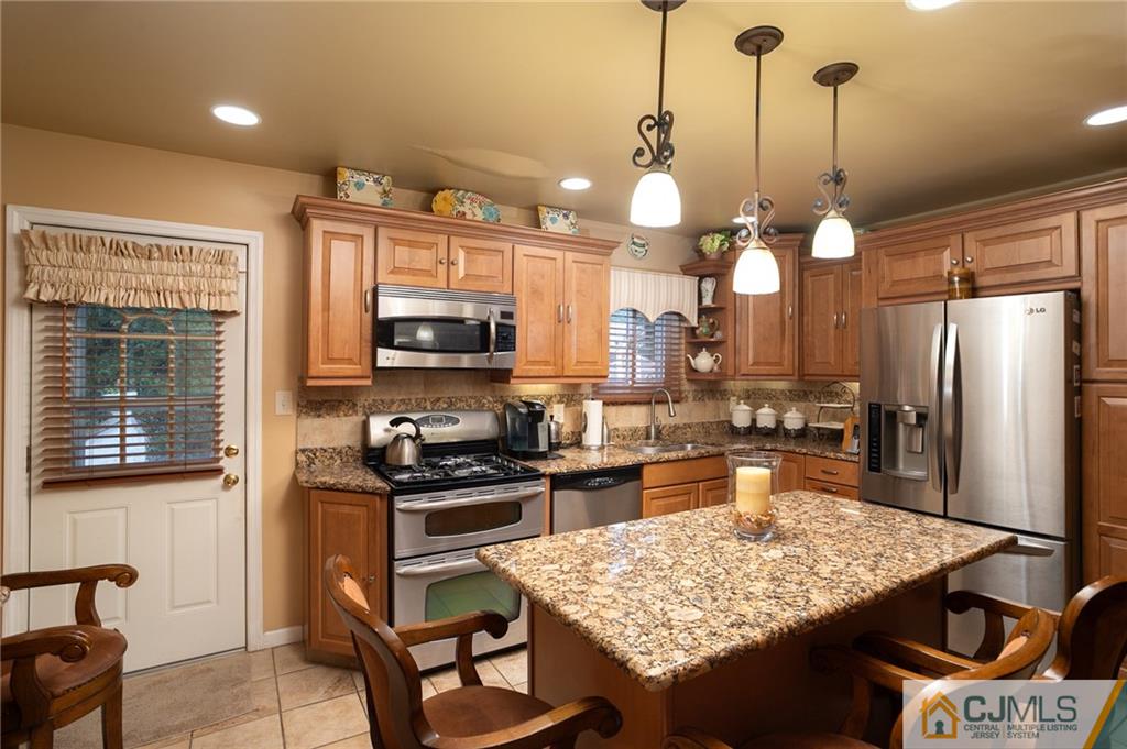 460 Warfield Road North Plainfield, NJ 07060 - Photo 10 of 29 a kitchen with stainless steel appliances granite countertop a sink stove and refrigerator