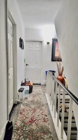 a living room with furniture and stairs