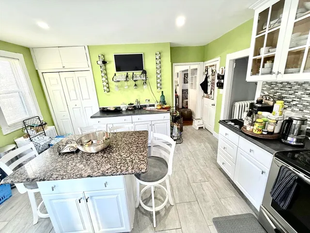 a kitchen with sink stove and refrigerator