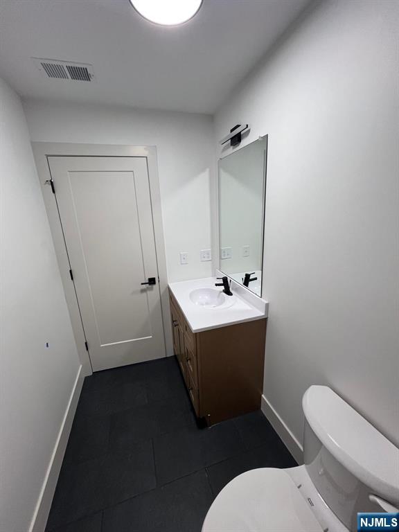 1060 Magnolia Avenue Elizabeth, NJ 07201 - Photo 21 of 22 a bathroom with a sink and mirror with toilet