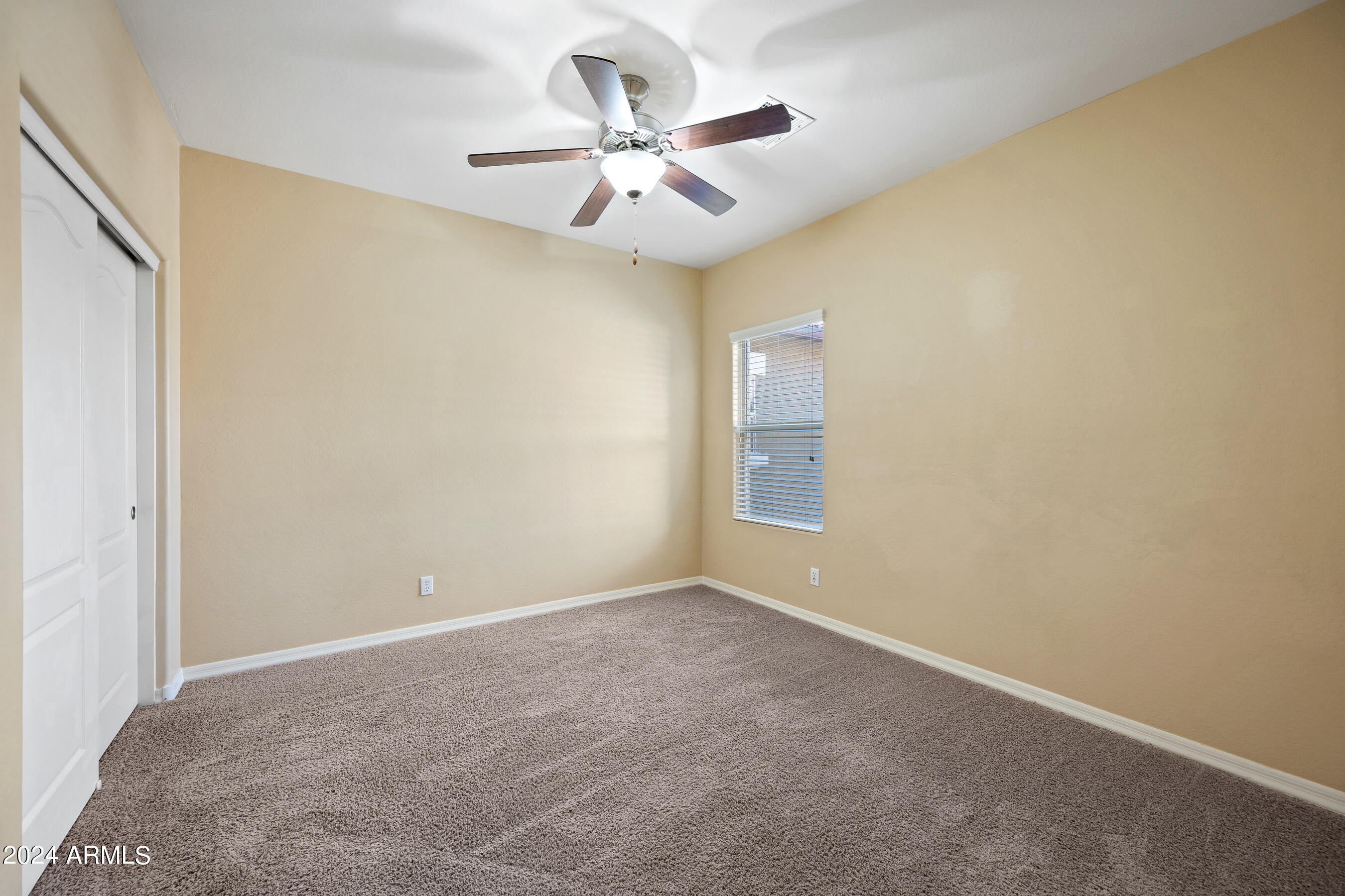 7726 East Baseline Road, Unit 235 Mesa, AZ 85209 - Photo 22 of 31 an empty room with a ceiling fan and wooden floor