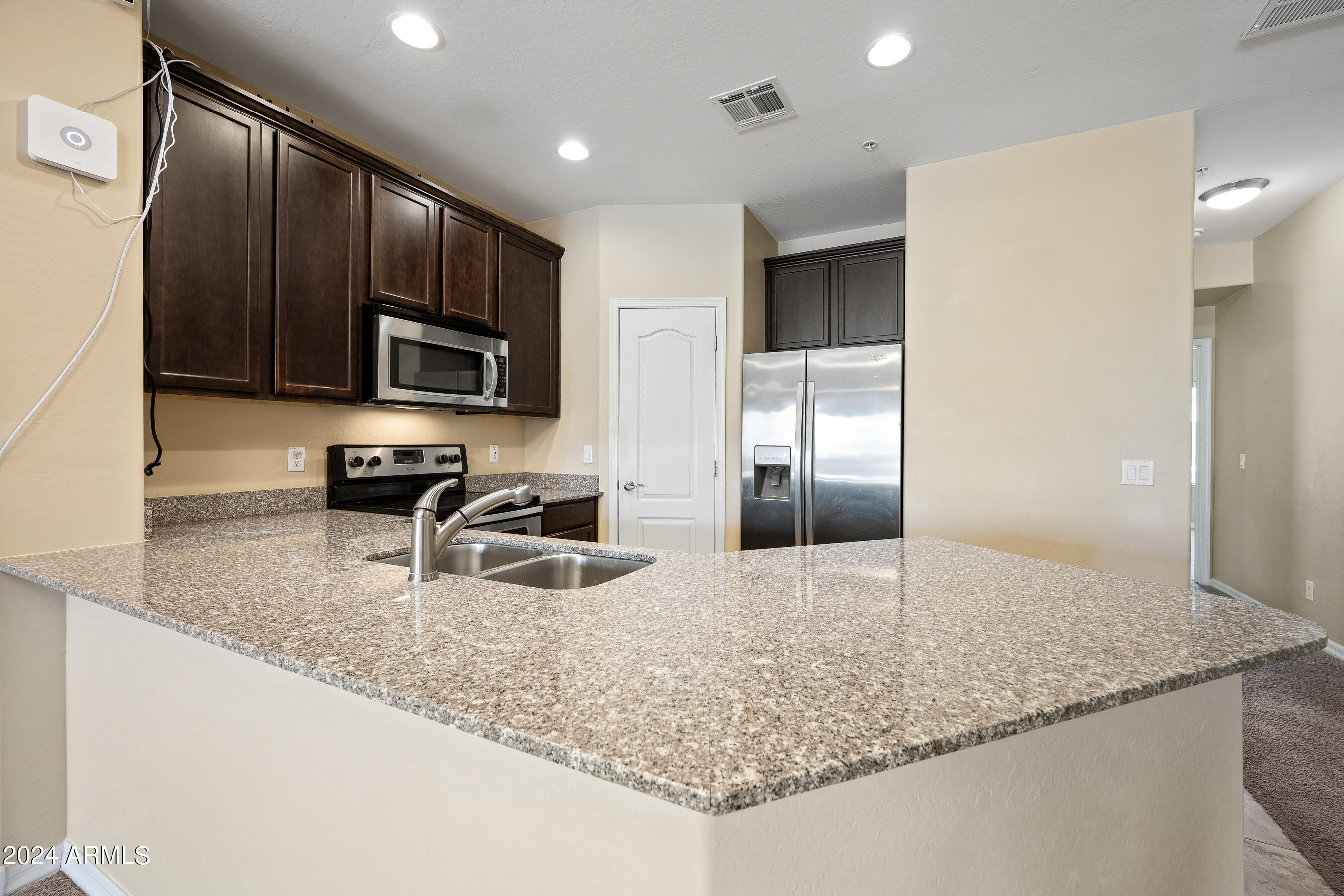7726 East Baseline Road, Unit 235 Mesa, AZ 85209 - Photo 9 of 31 a kitchen with stainless steel appliances granite countertop a sink refrigerator and microwave