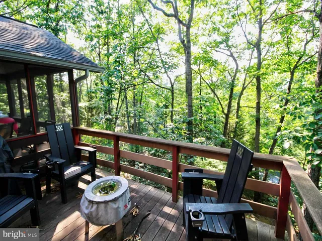 a view of a balcony with wooden floor and furniture