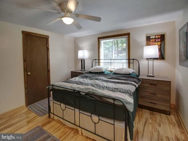 a bedroom with a bed and a window