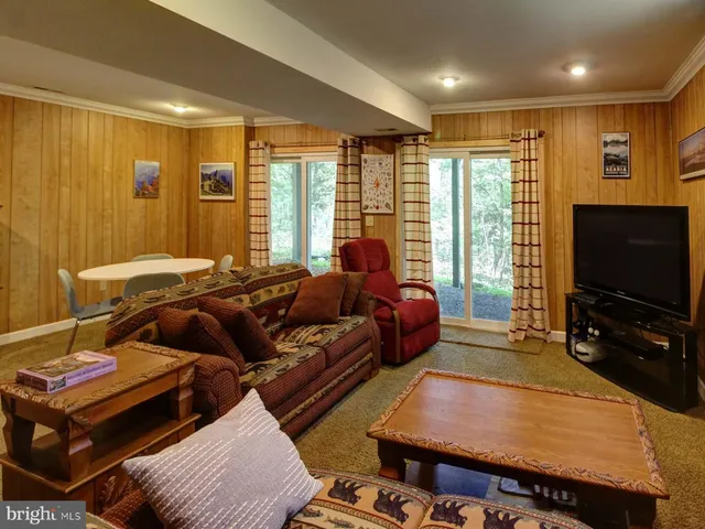 a bedroom with furniture and a flat screen tv