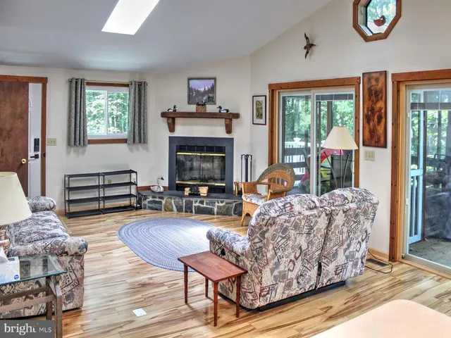 a living room with furniture fireplace and flat screen tv