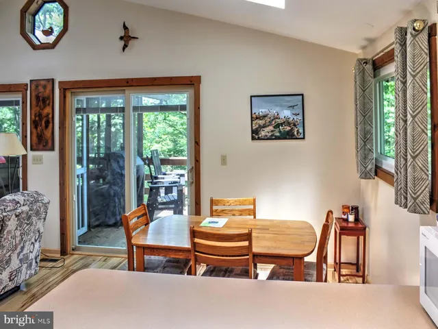 a living room with furniture a window and a table