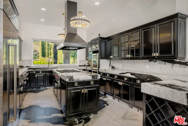 a kitchen with a stove a refrigerator and a dining table