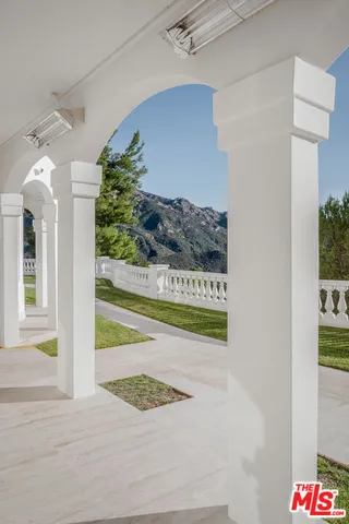 a living room with furniture and large windows