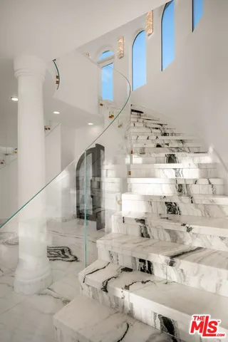 a large white building with glass door and windows