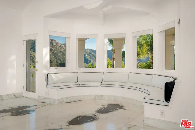 a large bedroom with a large bed and a fireplace