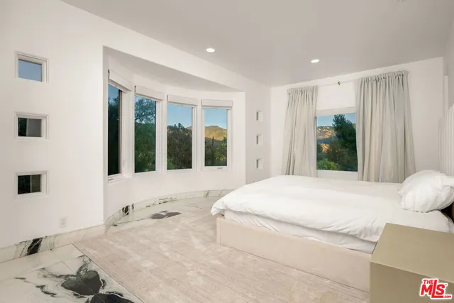 a living room with a bed and window