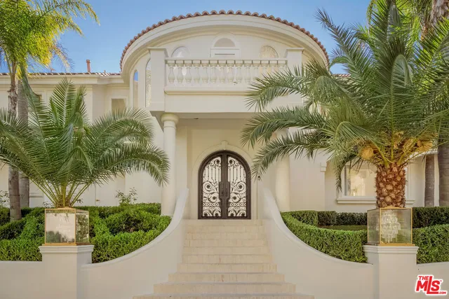 a view of a house with a fountain in a yard