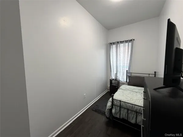 a bedroom with a bed and flat screen tv