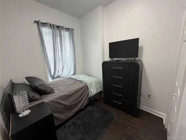a bedroom with a bed and a television