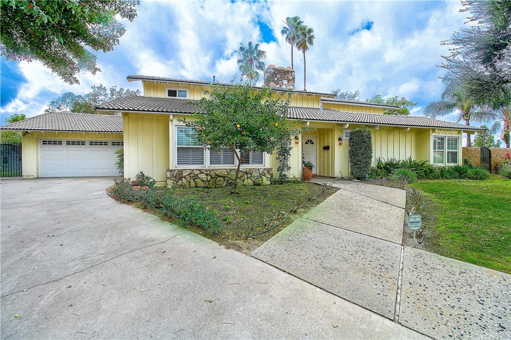 1546 Regal Court Riverside, CA 92506 - Photo 1 of 1 a front view of a house with a yard and garage