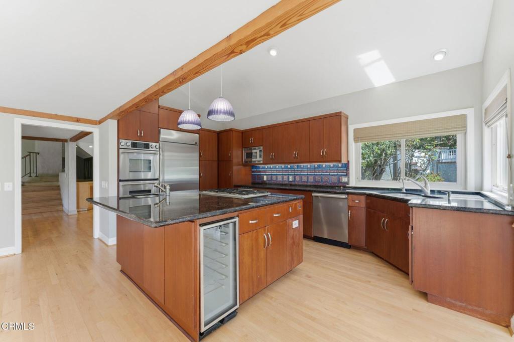 405 Woodcliffe Road Pasadena, CA 91105 - Photo 22 of 65 a large kitchen with stainless steel appliances granite countertop a large counter top and a stove