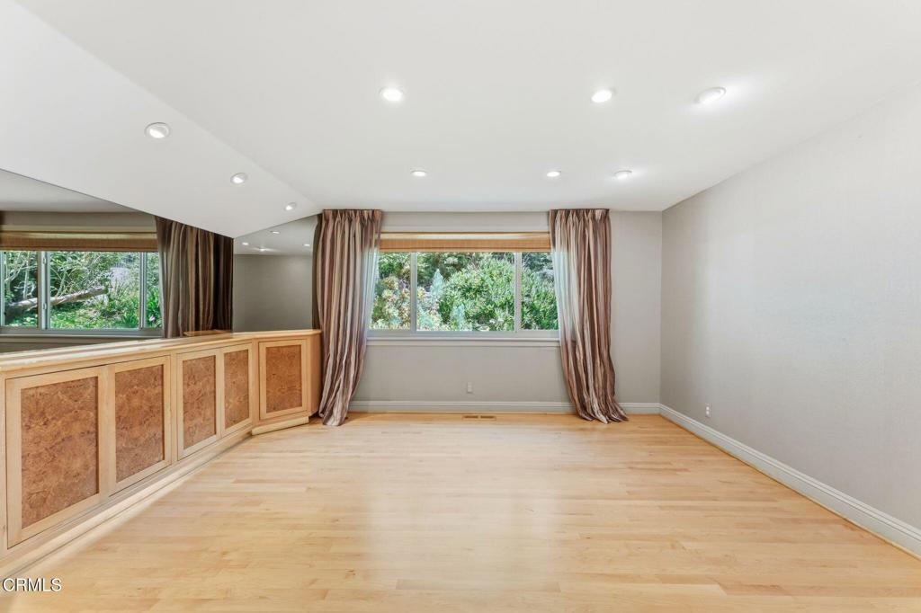 405 Woodcliffe Road Pasadena, CA 91105 - Photo 25 of 65 a view of an empty room with wooden floor and a window