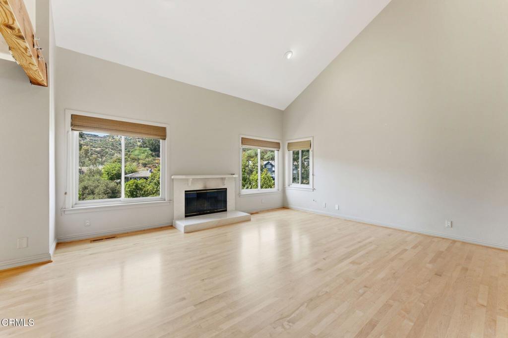 405 Woodcliffe Road Pasadena, CA 91105 - Photo 3 of 65 an empty room with floor to ceiling window and fireplace