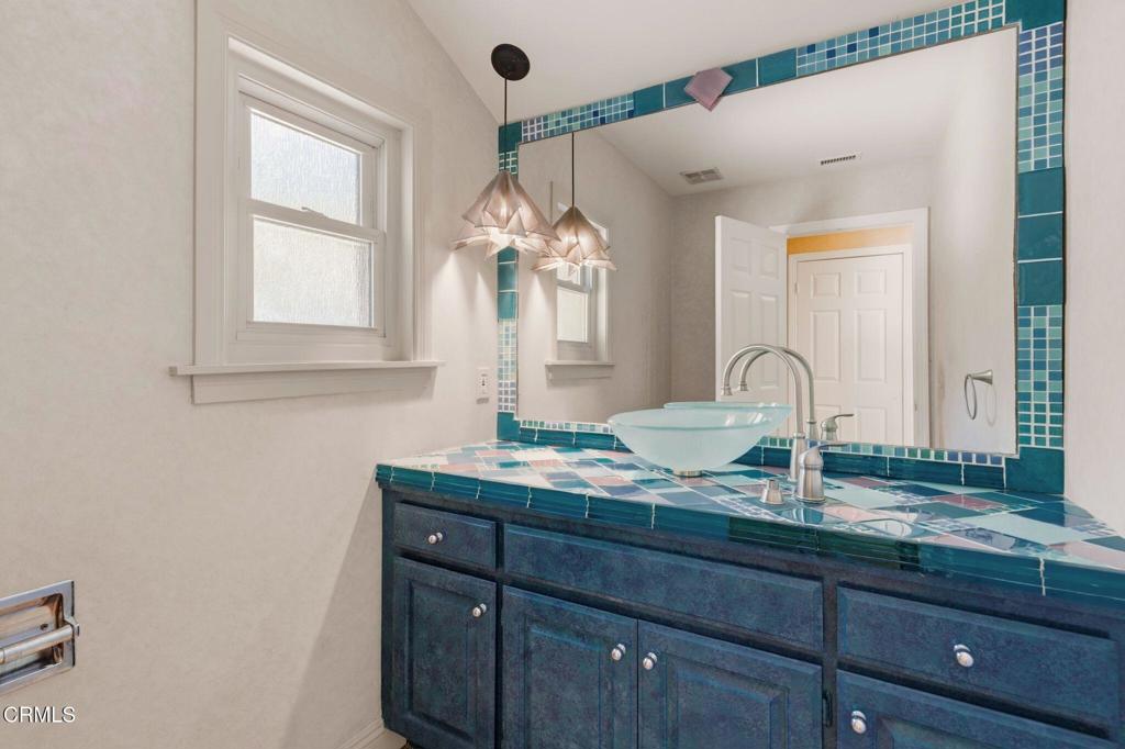 405 Woodcliffe Road Pasadena, CA 91105 - Photo 35 of 65 a bathroom with a granite countertop sink a mirror and window