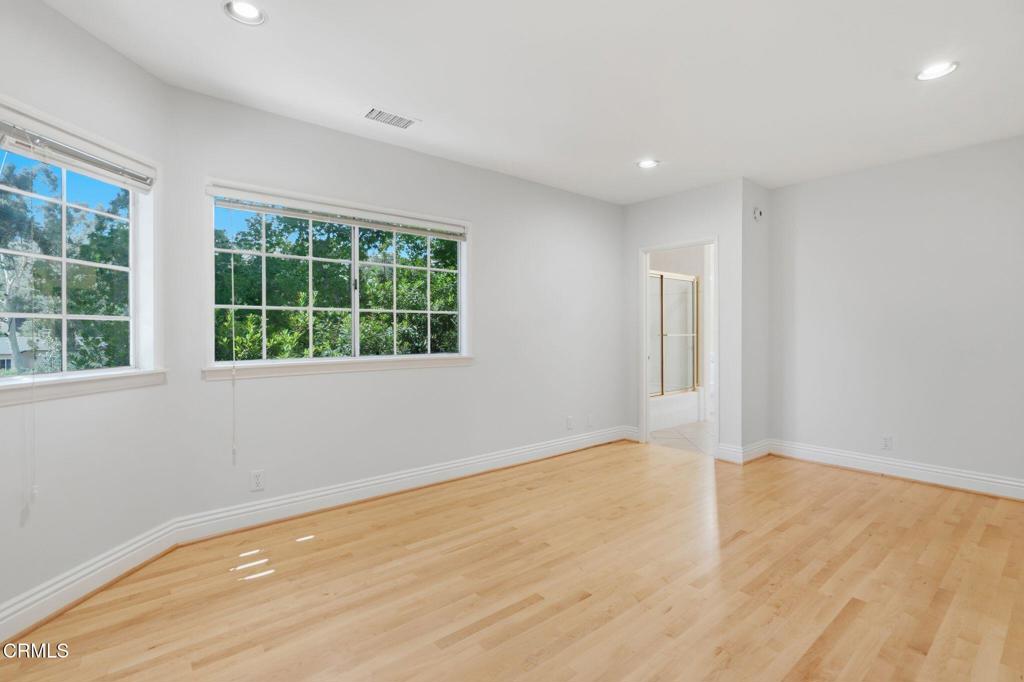 405 Woodcliffe Road Pasadena, CA 91105 - Photo 45 of 65 a view of an empty room with wooden floor and windows