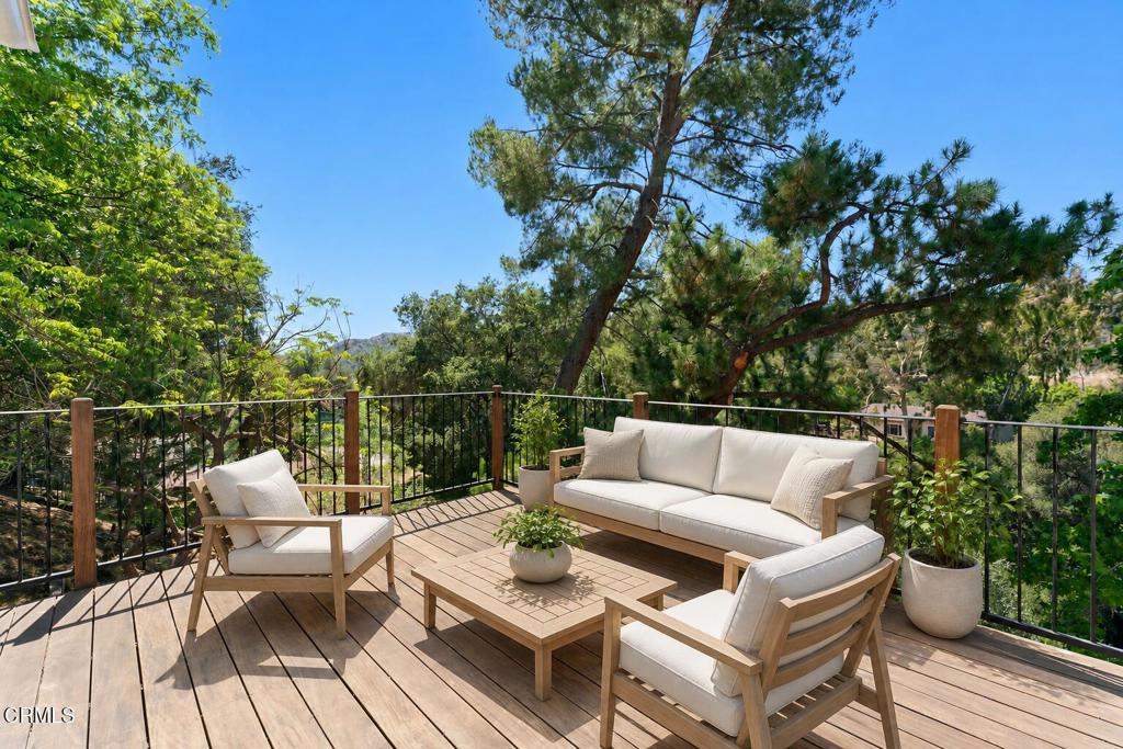 405 Woodcliffe Road Pasadena, CA 91105 - Photo 54 of 65 a view of a patio with couches and a table and chairs with wooden floor and fence