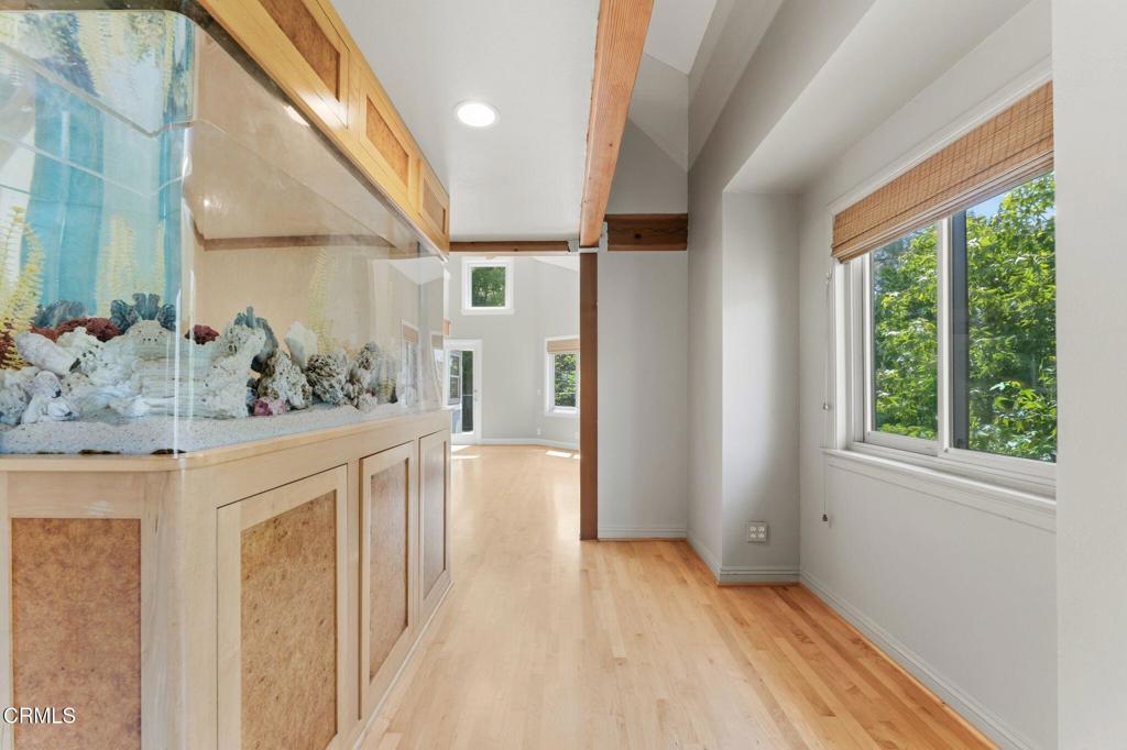 405 Woodcliffe Road Pasadena, CA 91105 - Photo 9 of 65 a view of a hallway to a bedroom with wooden floor and windows