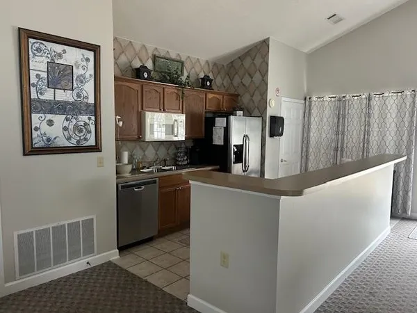 a kitchen with stainless steel appliances a refrigerator and a stove top oven