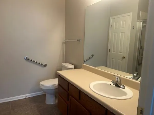 a bathroom with a sink toilet and a mirror
