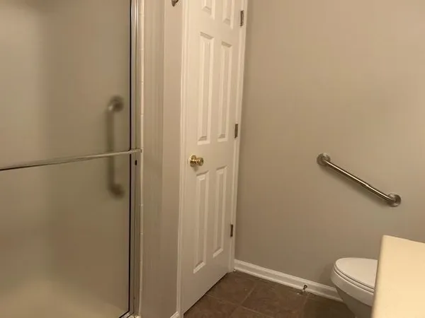 a bathroom with a shower and a toilet