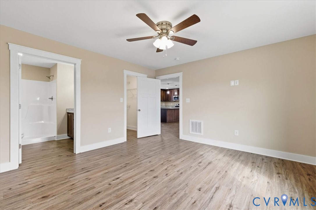 1588 Lansing Road Petersburg, VA 23805 - Photo 16 of 25 Unfurnished bedroom featuring a walk in closet, li