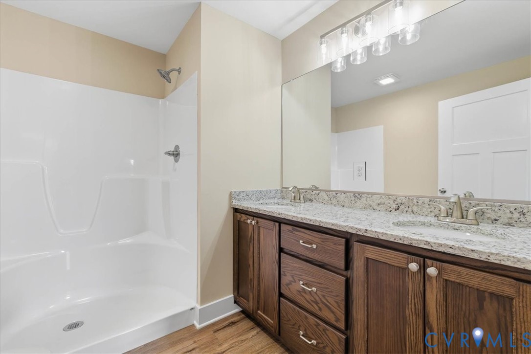 1588 Lansing Road Petersburg, VA 23805 - Photo 17 of 25 Bathroom with double vanity, light wood-type floor