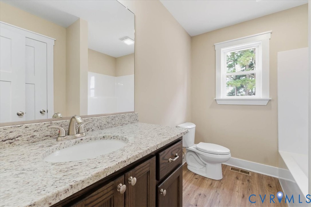 1588 Lansing Road Petersburg, VA 23805 - Photo 21 of 25 Bathroom featuring light wood-style flooring, vani