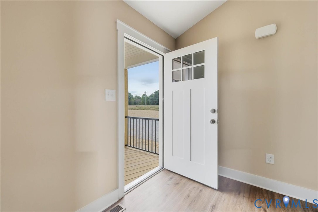 1588 Lansing Road Petersburg, VA 23805 - Photo 4 of 25 Doorway featuring baseboards and wood finished flo