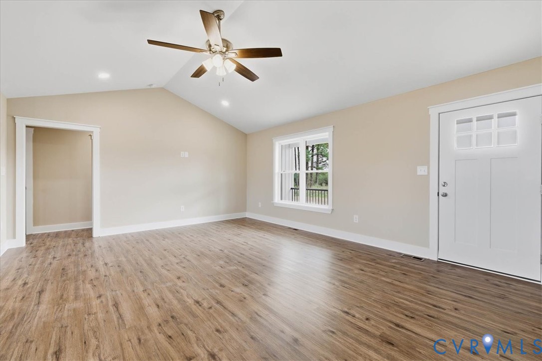 1588 Lansing Road Petersburg, VA 23805 - Photo 6 of 25 Unfurnished living room with vaulted ceiling, ligh