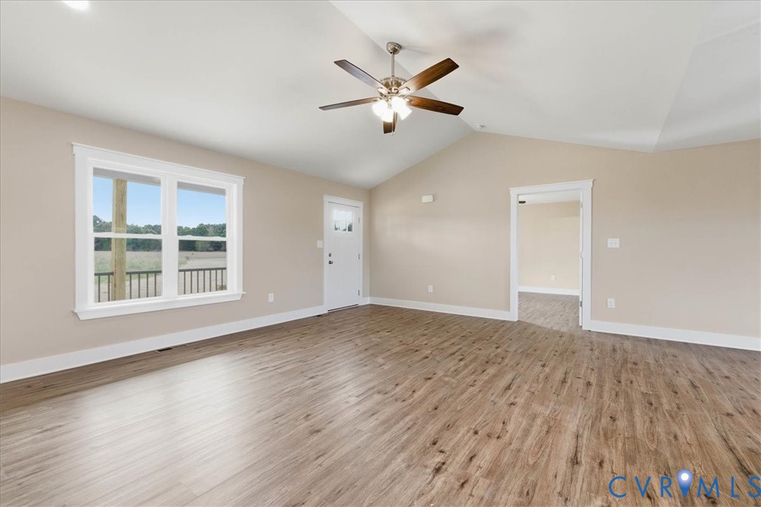 1588 Lansing Road Petersburg, VA 23805 - Photo 7 of 25 Unfurnished living room with vaulted ceiling, ligh