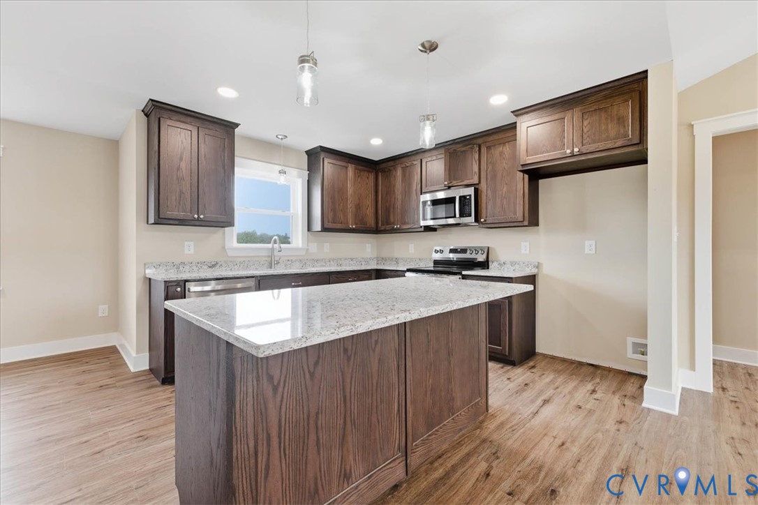 1588 Lansing Road Petersburg, VA 23805 - Photo 9 of 25 Kitchen featuring light stone counters, dark brown