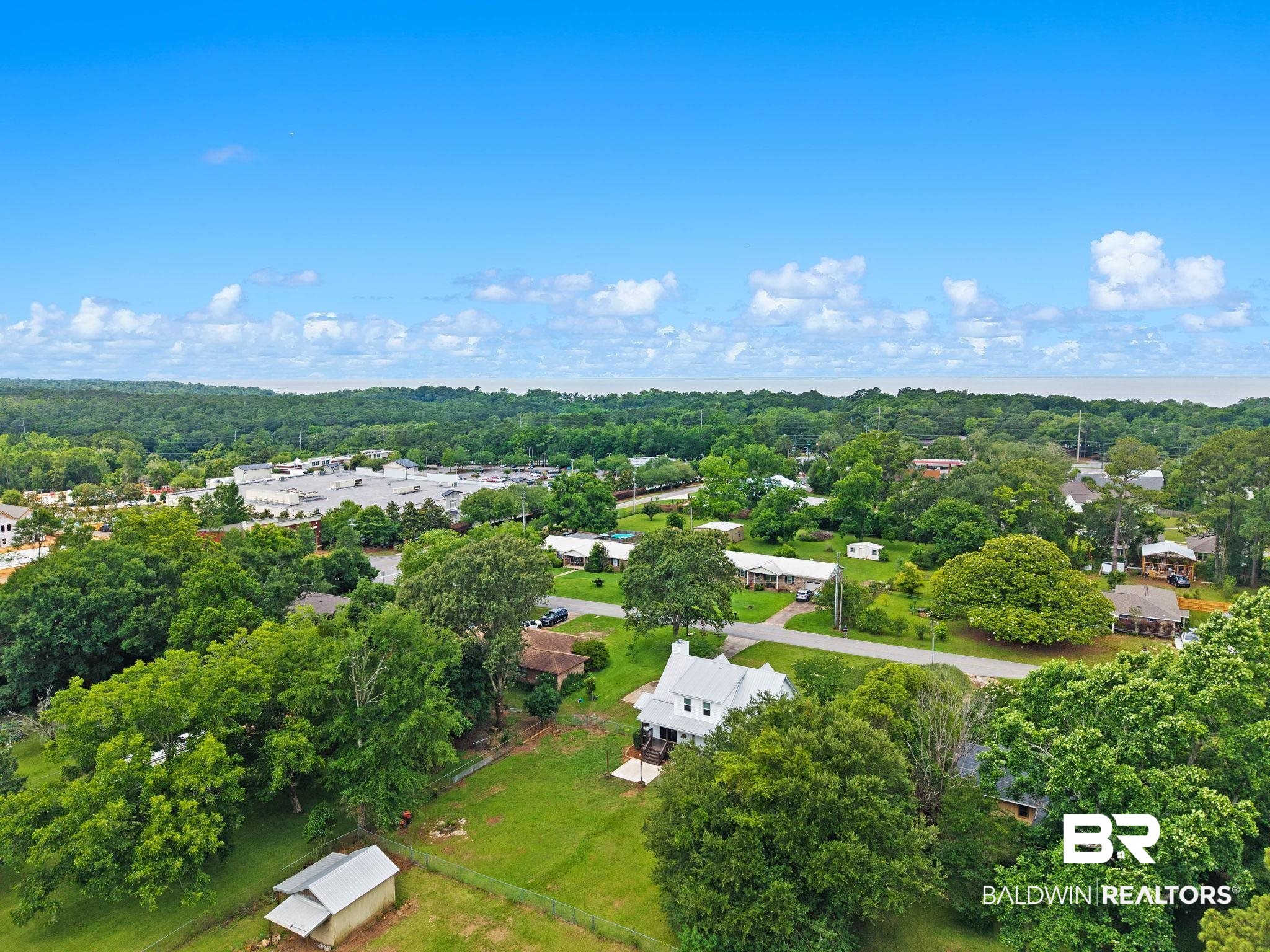 22810 High Ridge Road Fairhope, AL 36532 - Photo 70 of 78 Expansive green landscape featuring a prominent white two-story residence with a covered porch