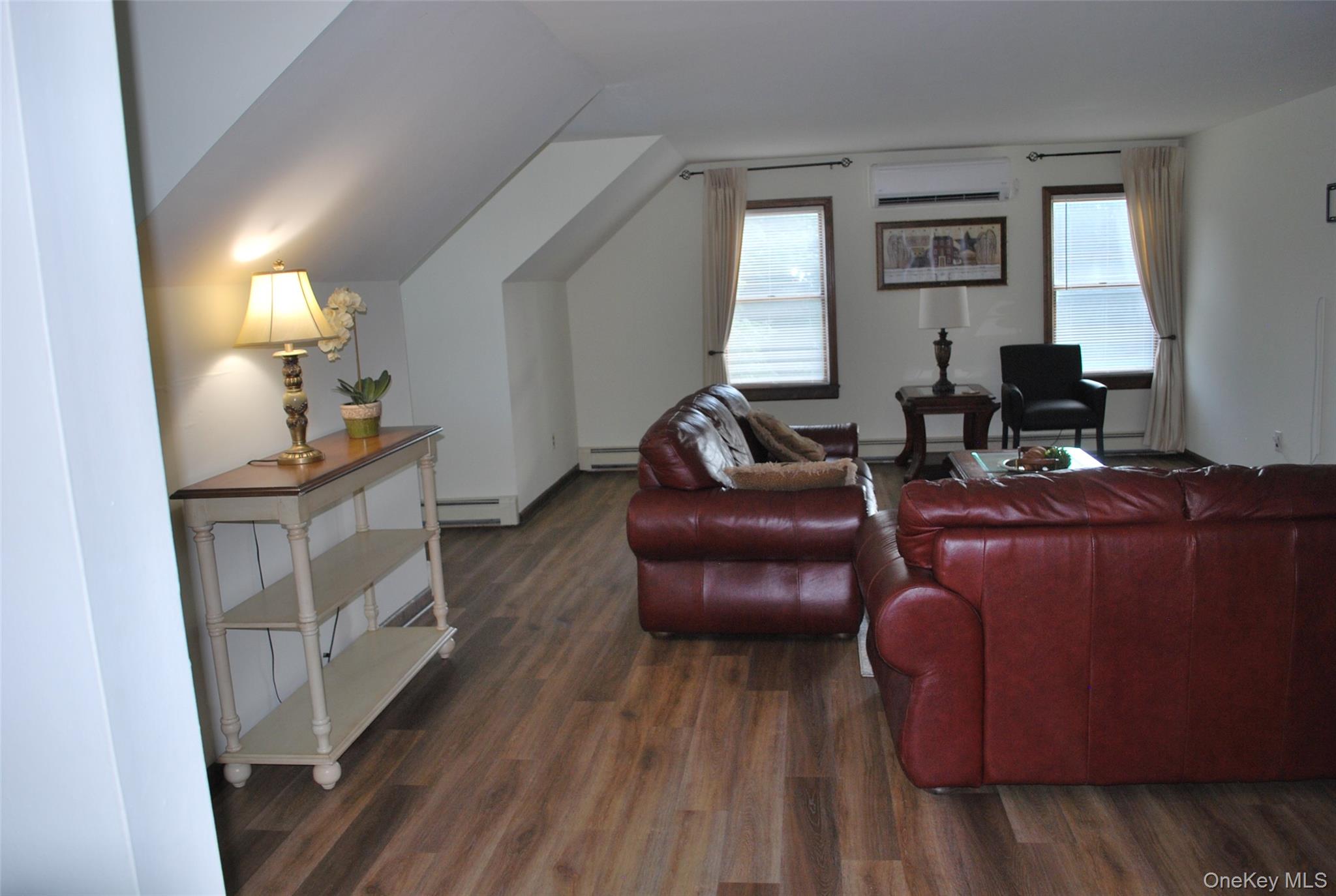 25 Hathorn Road, Unit 2 Warwick, NY 10990 - Photo 2 of 10 a living room with furniture and a fireplace