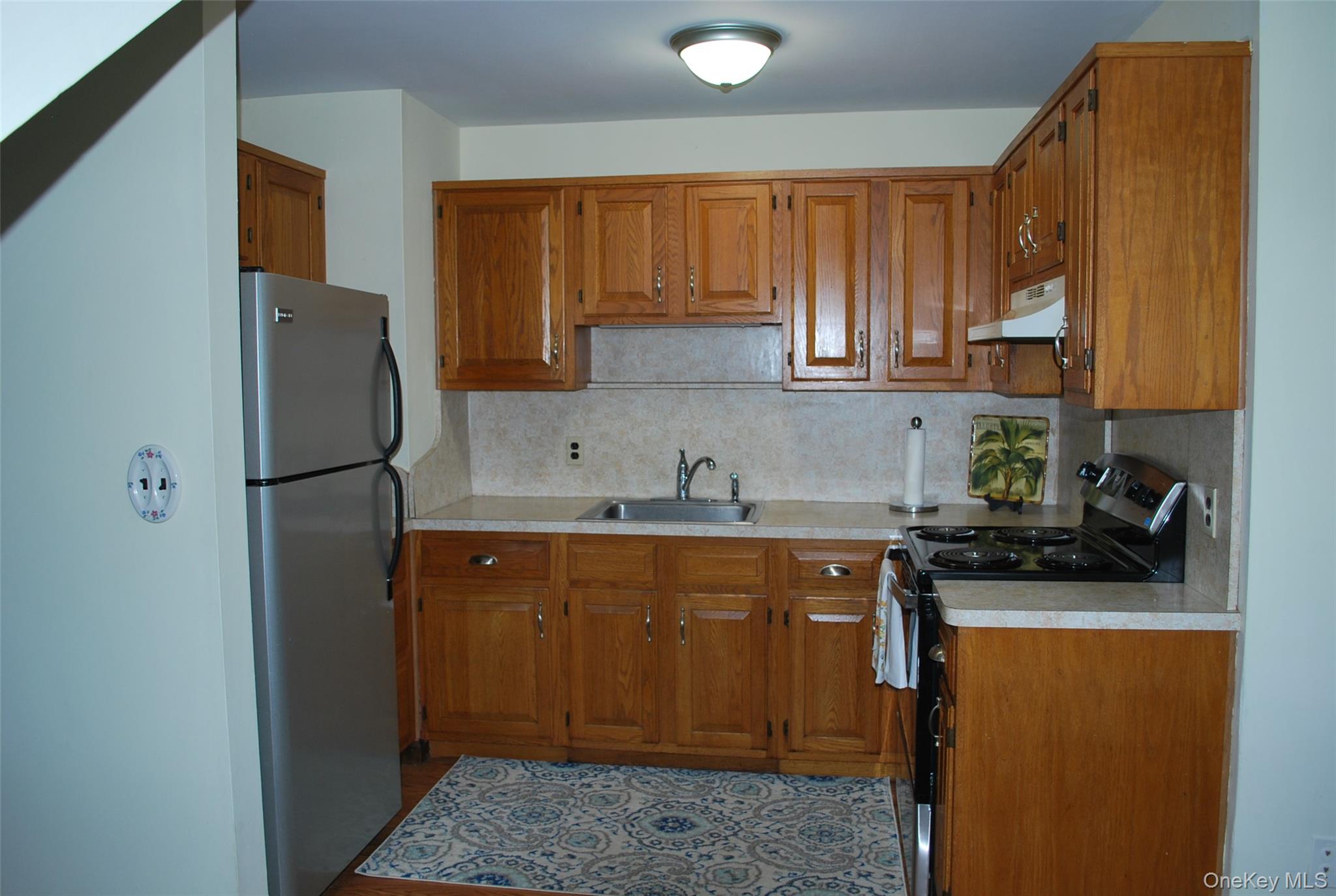 25 Hathorn Road, Unit 2 Warwick, NY 10990 - Photo 4 of 10 a kitchen with stainless steel appliances granite countertop a refrigerator and a sink