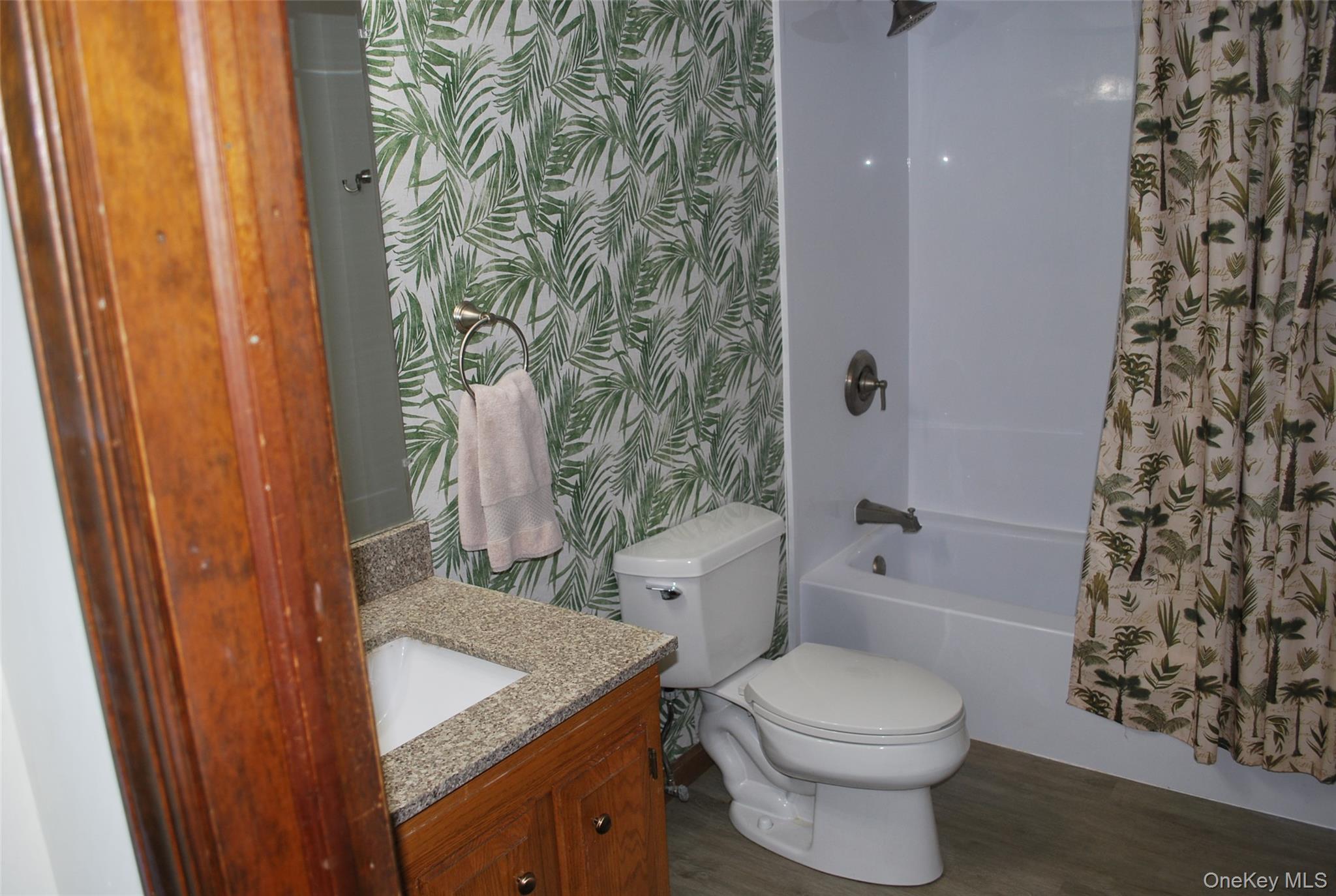 25 Hathorn Road, Unit 2 Warwick, NY 10990 - Photo 7 of 10 a bathroom with a sink a toilet and shower curtain