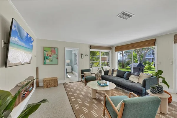 a living room with furniture and a large window