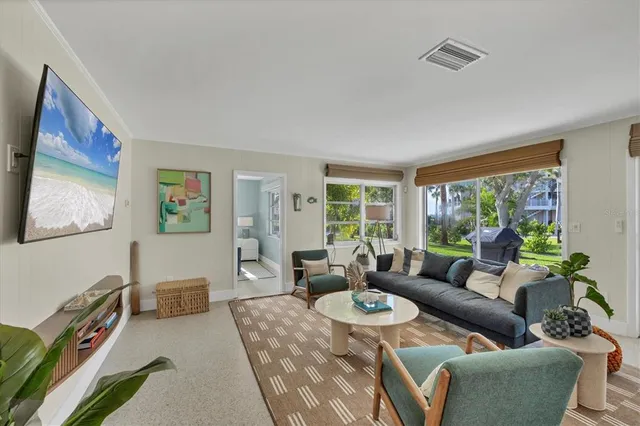 a living room with furniture and a large window