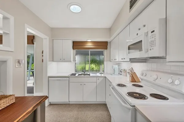 a kitchen that has a sink and cabinets