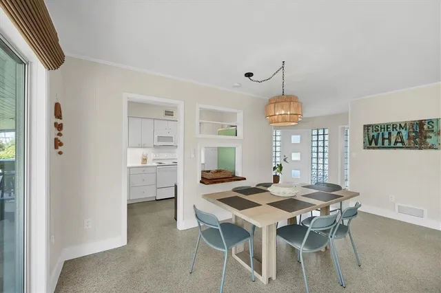 a view of a dining room with furniture window and outside view